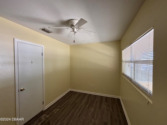 unfurnished room with dark hardwood / wood-style flooring and ceiling fan