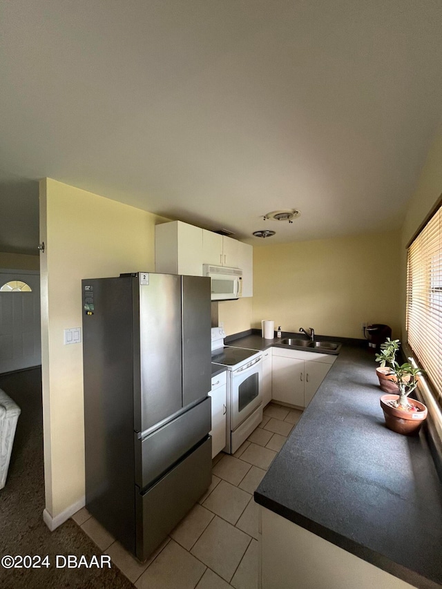 kitchen with white cabinetry, sink, and white appliances