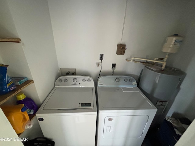 laundry area with washing machine and clothes dryer and water heater