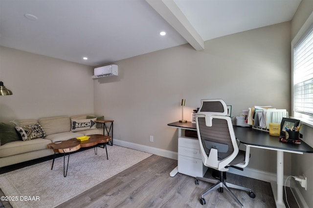 office with a wall mounted AC, beamed ceiling, and wood-type flooring