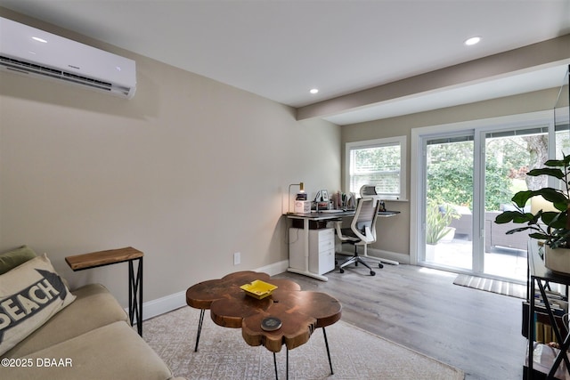 office space featuring light hardwood / wood-style floors and a wall mounted air conditioner