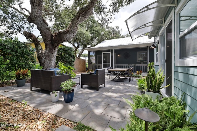 view of patio with a sunroom and outdoor lounge area