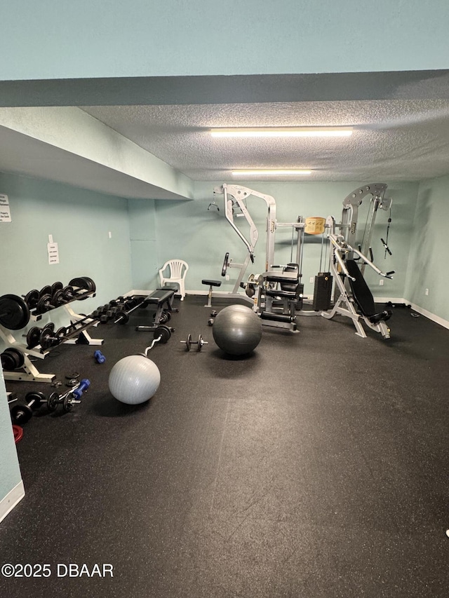 exercise room featuring a textured ceiling