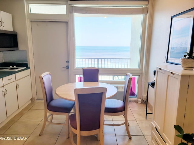 tiled dining space with a water view