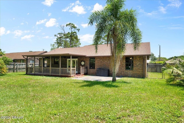 back of property with a patio and a yard