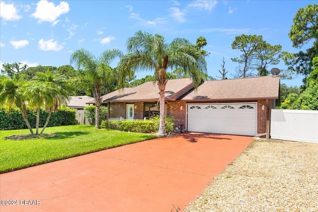 single story home featuring a garage and a front yard