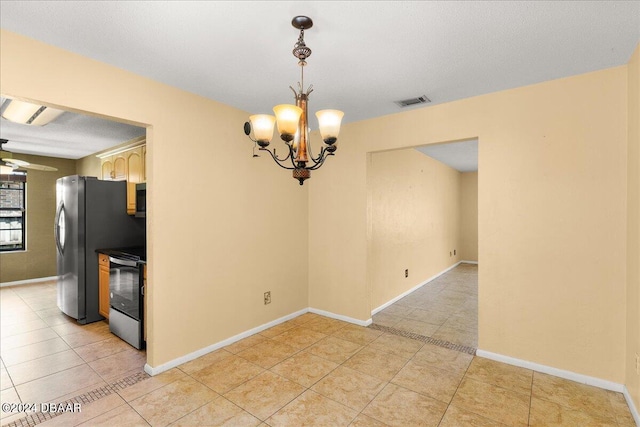 unfurnished dining area featuring light tile patterned flooring and ceiling fan with notable chandelier