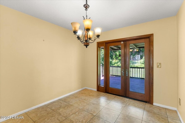 entryway featuring french doors, light tile patterned floors, and a chandelier