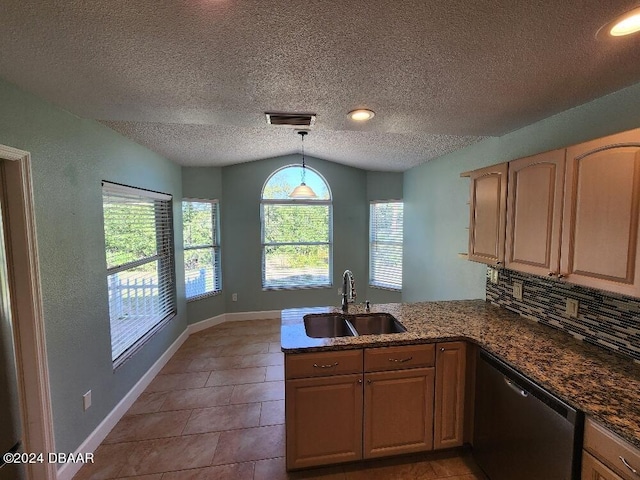 kitchen featuring decorative light fixtures, a textured ceiling, sink, dishwasher, and kitchen peninsula