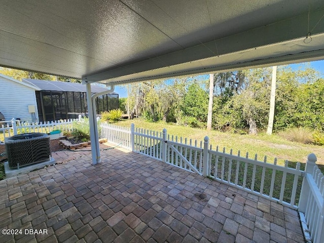 view of patio featuring a sunroom and central AC