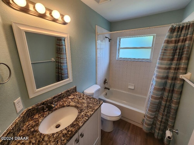 full bathroom with hardwood / wood-style flooring, vanity, toilet, and shower / tub combo