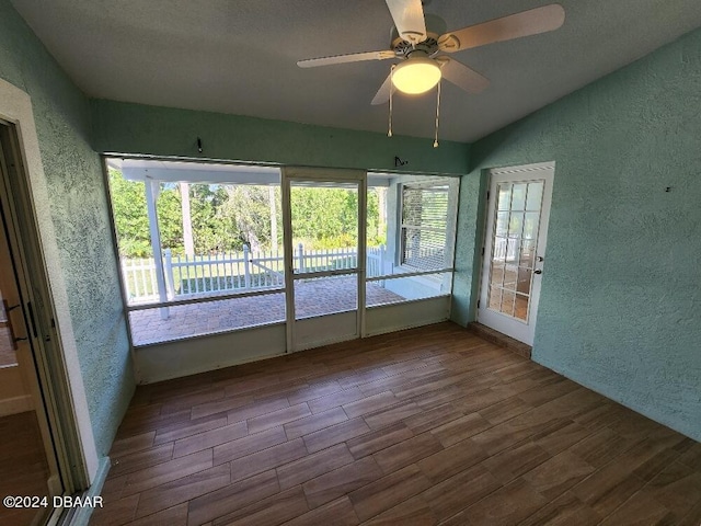 unfurnished sunroom with ceiling fan