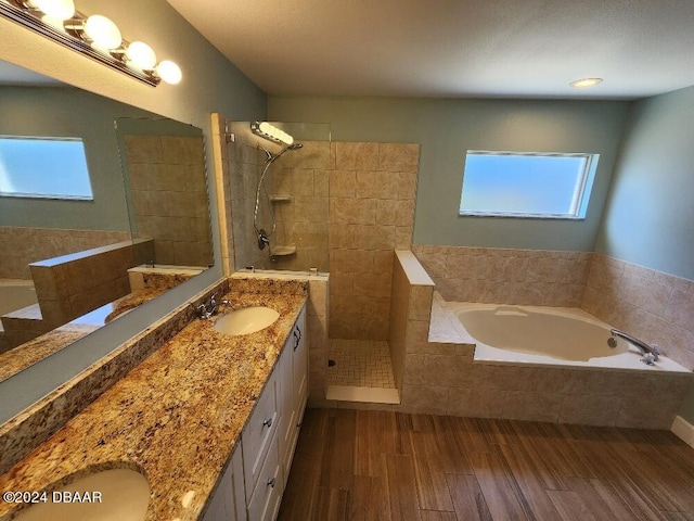 bathroom featuring wood-type flooring, vanity, and separate shower and tub