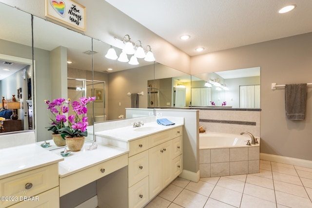 10 Foxhunter Flt, Ormond Beach, FL 32174 - bathroom featuring tile patterned floors, baseboards, a shower stall, and a garden tub