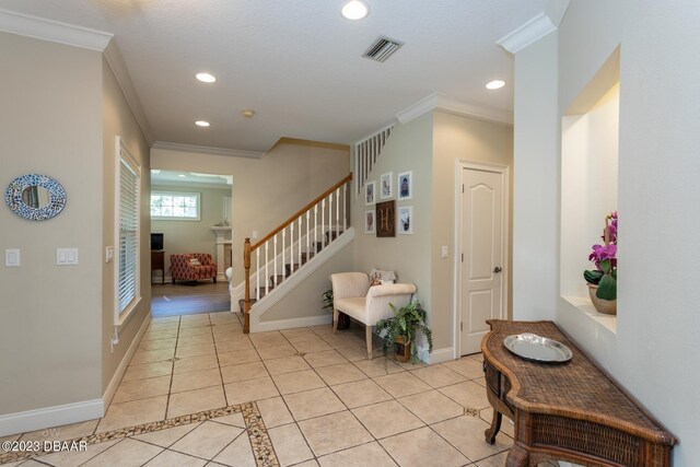 10 Foxhunter Flt, Ormond Beach, FL 32174 - entrance foyer with stairs, light tile patterned floors, ornamental molding, and recessed lighting