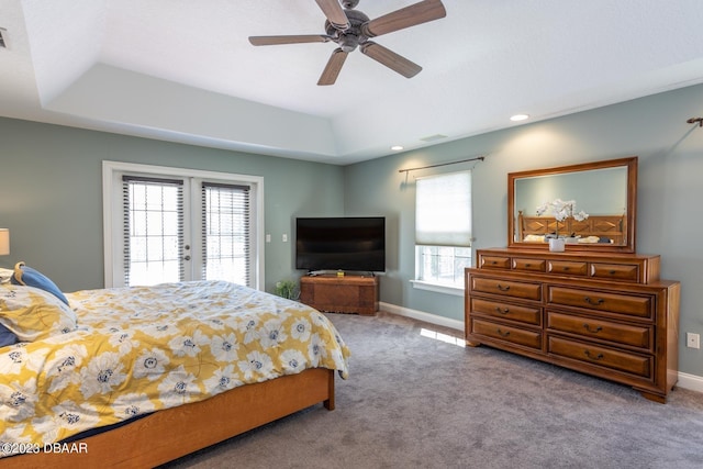 10 Foxhunter Flt, Ormond Beach, FL 32174 - bedroom featuring a raised ceiling, french doors, access to exterior, carpet floors, and a ceiling fan