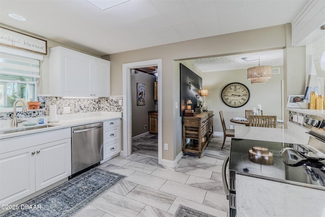 kitchen with sink, tasteful backsplash, hanging light fixtures, stainless steel appliances, and white cabinets