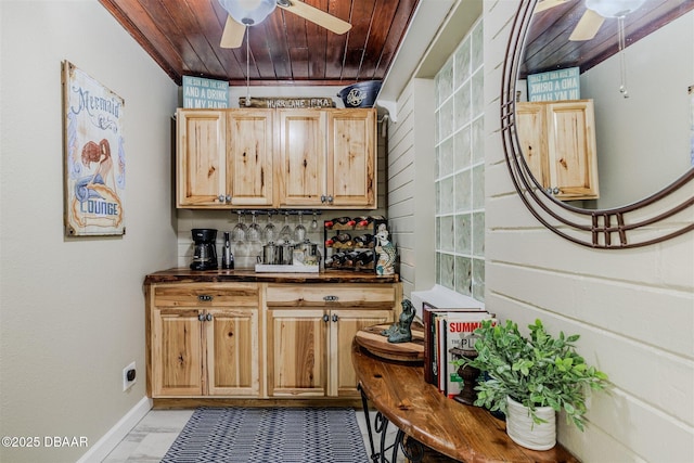 bar with ceiling fan, light brown cabinets, and wood ceiling