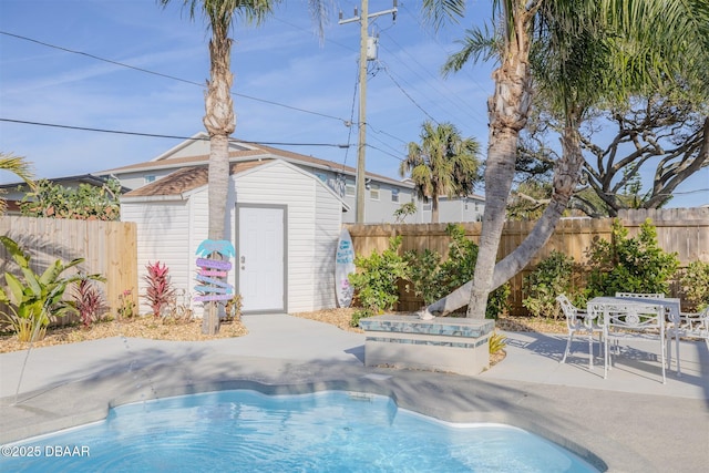 view of swimming pool with a hot tub, a patio, and a storage unit