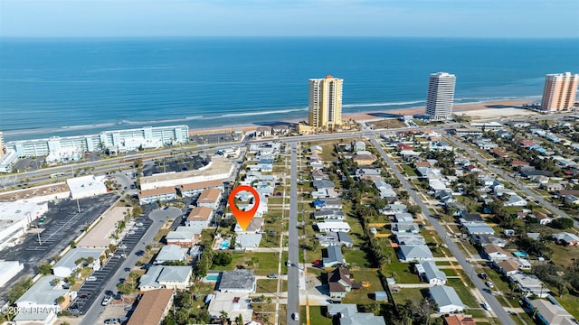 bird's eye view featuring a water view and a view of the beach