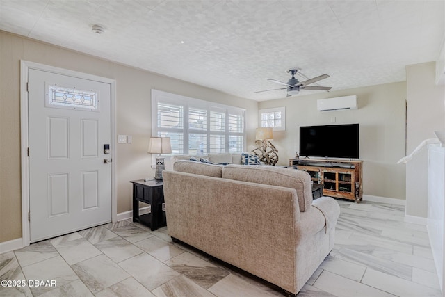 living room featuring ceiling fan and a wall unit AC