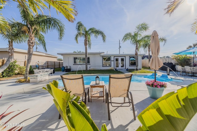 view of swimming pool with an outbuilding, pool water feature, and a patio area