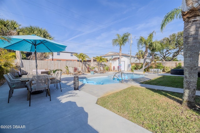 view of swimming pool featuring a patio, a shed, and a lawn