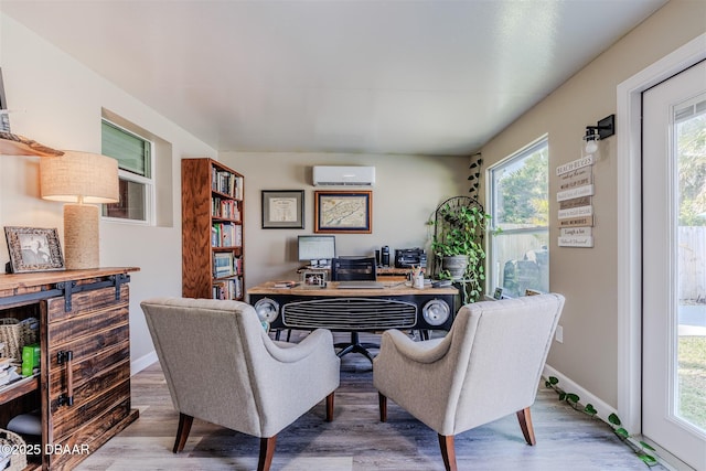 office with wood-type flooring and a wall unit AC