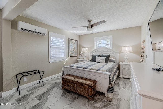 bedroom with ceiling fan and an AC wall unit