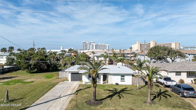 view of front of property featuring a garage and a front yard