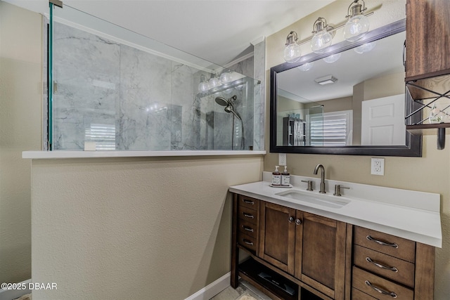 bathroom with tiled shower and vanity