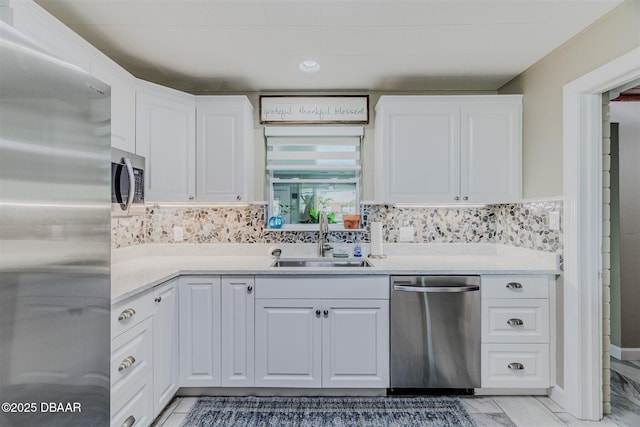 kitchen featuring appliances with stainless steel finishes, sink, and white cabinets