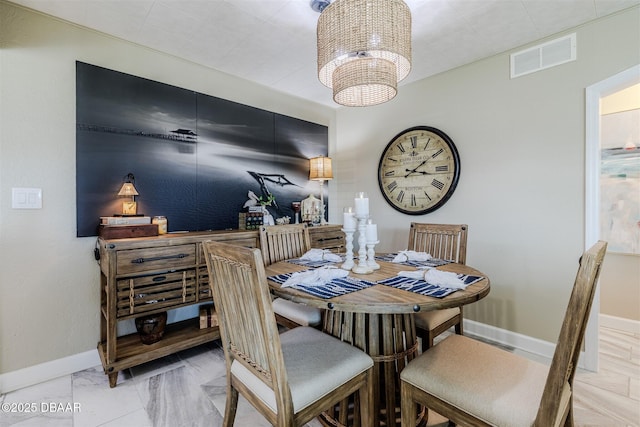 dining area featuring a notable chandelier