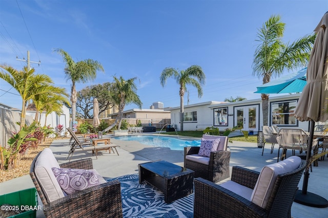 view of pool featuring a patio, outdoor lounge area, and pool water feature