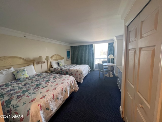 bedroom featuring carpet flooring, a closet, and crown molding