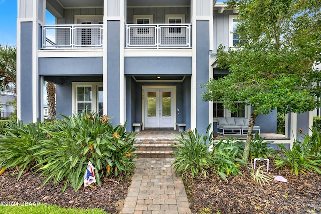 property entrance featuring outdoor lounge area, french doors, and a balcony