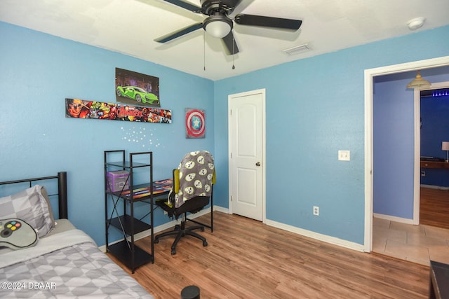 bedroom featuring wood-type flooring and ceiling fan