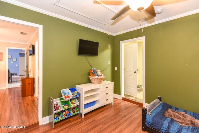 bedroom featuring ornamental molding, hardwood / wood-style floors, and ceiling fan