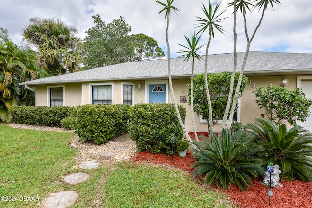 ranch-style home featuring a front yard