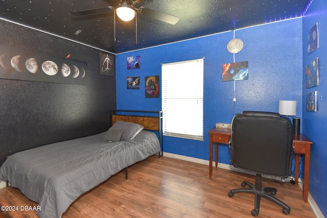 bedroom with hardwood / wood-style floors and ceiling fan