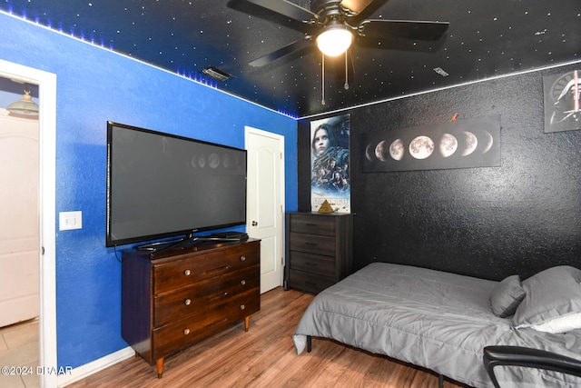 bedroom featuring wood-type flooring and ceiling fan