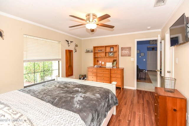 bedroom with ceiling fan, dark hardwood / wood-style floors, and crown molding