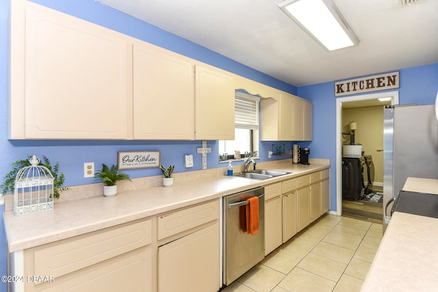 kitchen featuring appliances with stainless steel finishes, sink, and light tile patterned floors