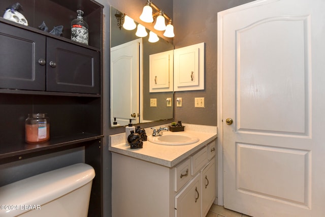 bathroom featuring vanity, tile patterned floors, and toilet