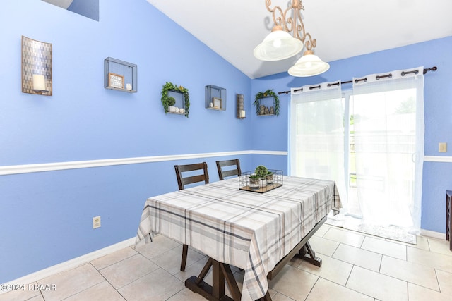 tiled dining room featuring lofted ceiling