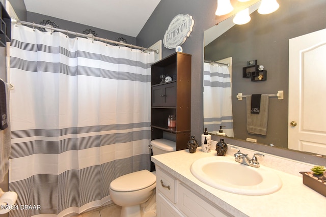 bathroom with toilet, vanity, and tile patterned floors