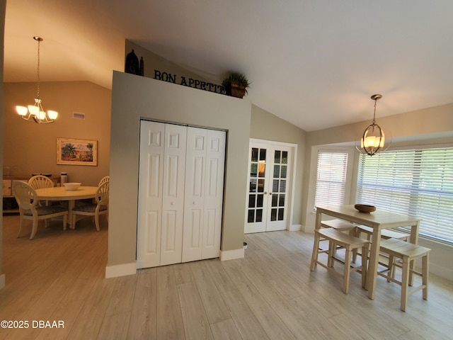 1941 Spruce Creek Lndg, Port Orange, FL 32128 - dining area featuring lofted ceiling, a chandelier, light wood finished floors, and french doors