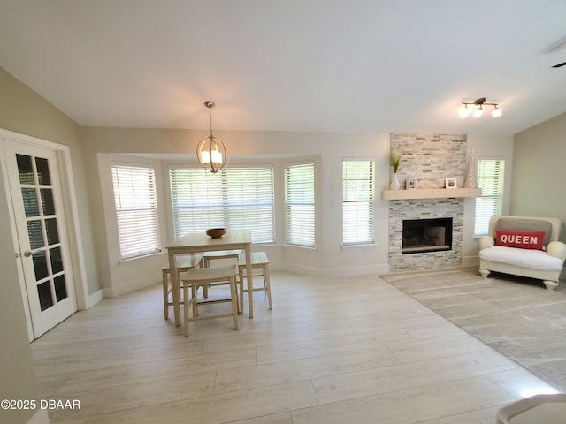 1941 Spruce Creek Lndg, Port Orange, FL 32128 - dining area featuring a fireplace, light wood finished floors, and lofted ceiling