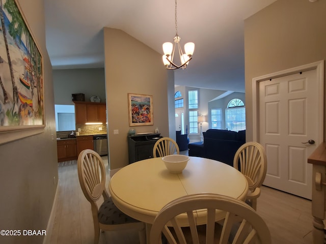 1941 Spruce Creek Lndg, Port Orange, FL 32128 - dining room with light wood-style floors, vaulted ceiling, and a chandelier