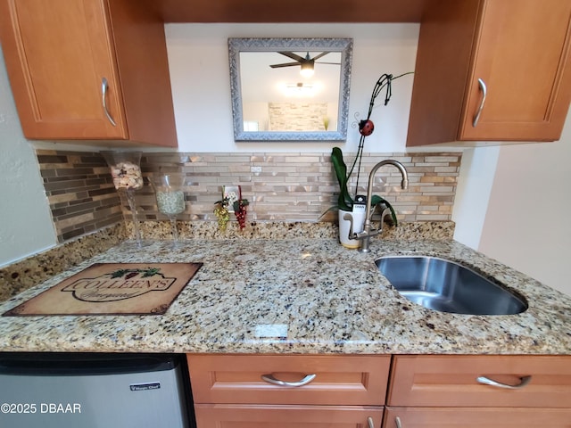 1941 Spruce Creek Lndg, Port Orange, FL 32128 - kitchen featuring backsplash, light stone countertops, and refrigerator